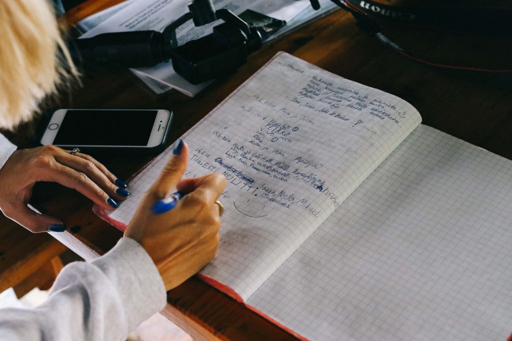 A girl signing a guest book in a cabin in Helvetinjärvi National Park.