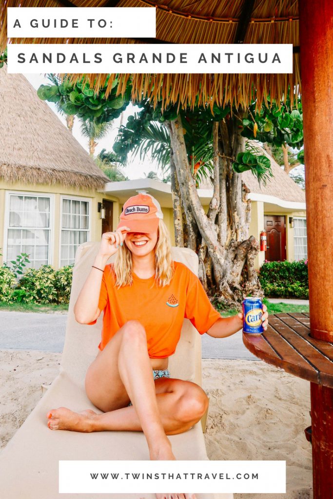 A girl drinking a beer at Sandals Grande Antigua Resort. Text overlay reads: 'A guide to: Sandals Grande Antigua' by 'Twins That Travel'.