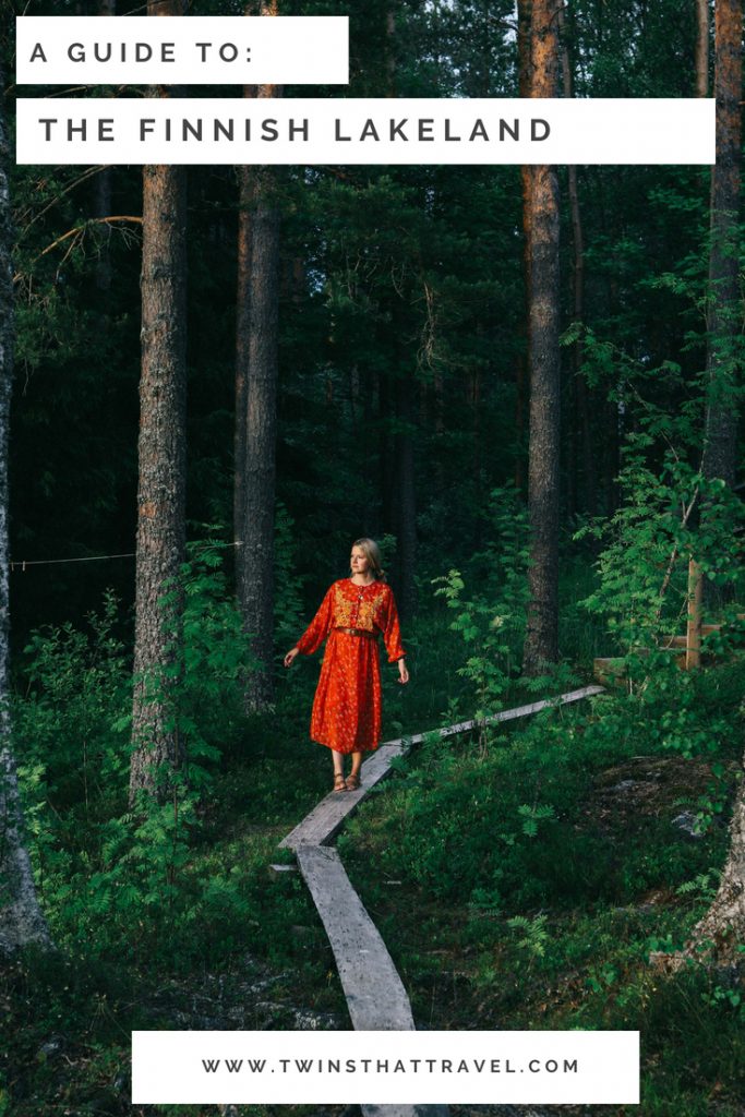 A girl stood in a forest in Tampere, Finland. Text overlay reads 'a guide to Finnish Lakeland'. Written by 'Twins That Travel'.